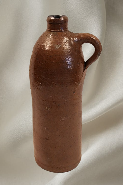Antique Stoneware Mineral Water Bottle from Selters Germany Circa 1840s cream fabric background