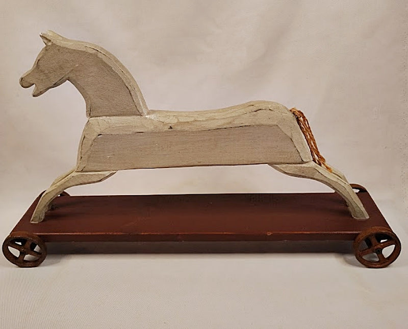 Folk Art Wood Horse Carved and Painted on Iron Wheels Facing Left