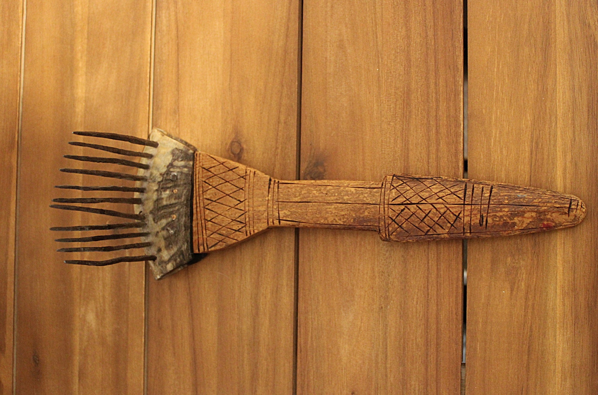 AfricanCarvedWoodenFiberCombwithForgedIronSpikes-Up-Facing-Front-left-table