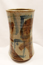 Cylindrical ceramic vase with abstract brown and blue patterns on a white background created by Bill Heduck potter -in 1993