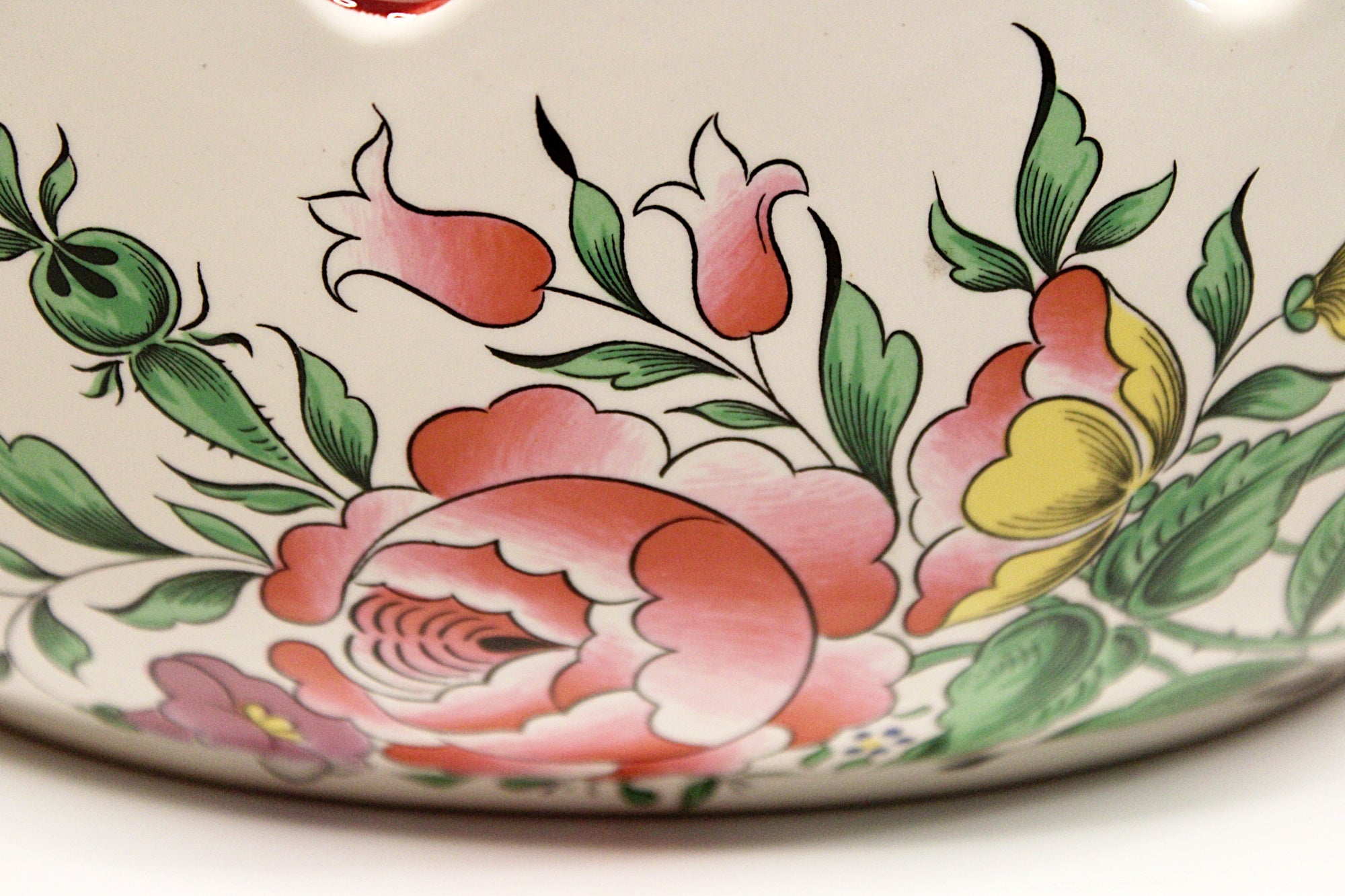 Decorative ceramic dish with floral patterns on a white background