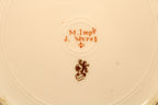 M. Imp Le d Sevres logo on a beige background