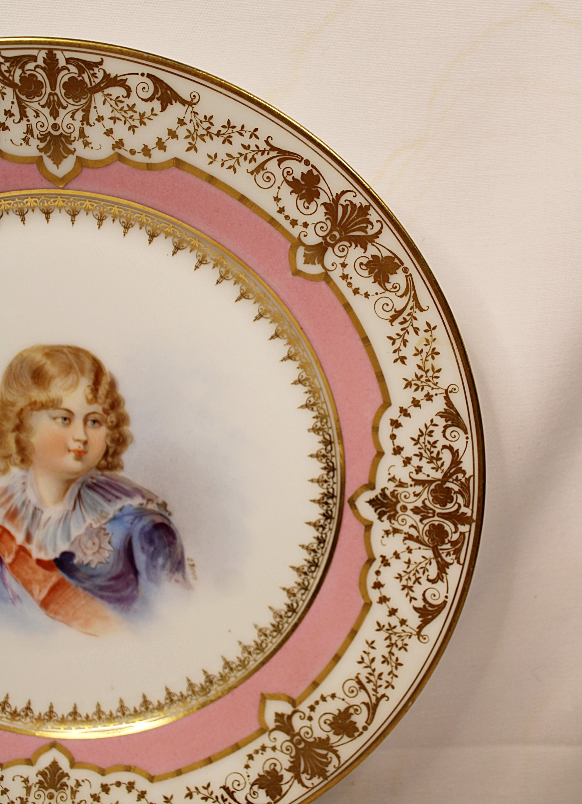 Decorative plate with a portrait of a young boy on a pink background Right Rim