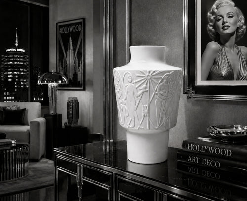 Decorative white vase on a table with Hollywood-themed decor in the background Marylin Monroe Picture