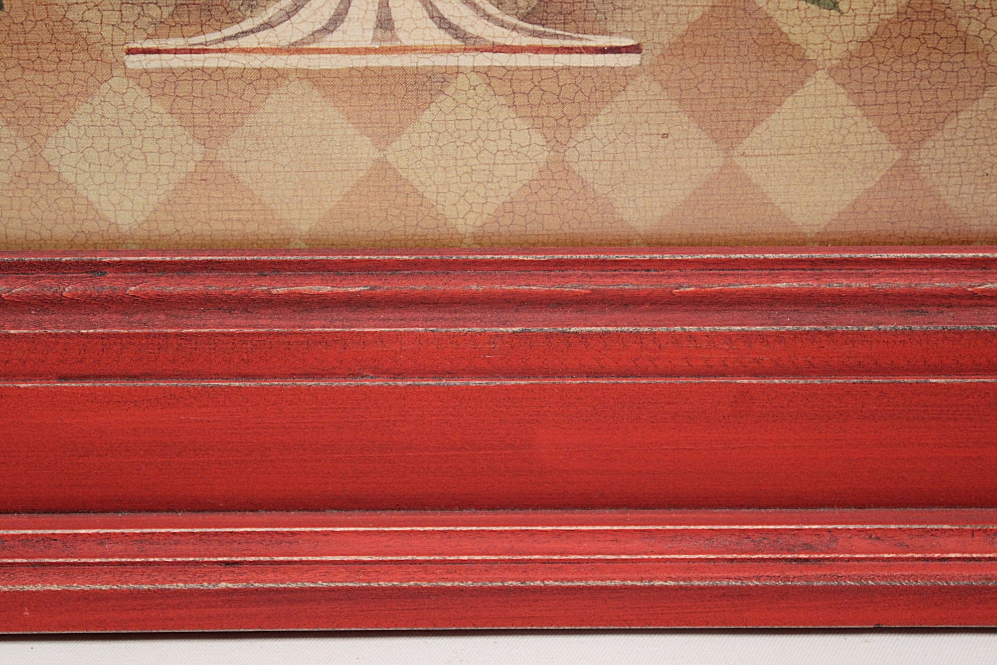 Close-up of a red wooden frame with a checkered pattern in the background