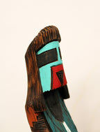 Wooden mask with colorful face on a beige background