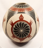 A hand-painted ceramic pot with a textured cream base, decorated with geometric patterns in black, red, and white.