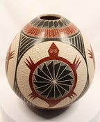 A hand-painted Southwestern-style ceramic vase with a textured cream base, featuring geometric patterns and a prominent red and black turtle design on the front, displayed on a white surface against a white background.