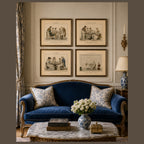 Blue velvet sofa in a room with framed artwork on the wall and decorative items on a table.
