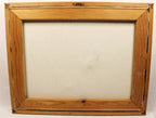 A wooden picture frame with a light brown pine finish and a blank off-white canvas insert, shown against a plain white background.