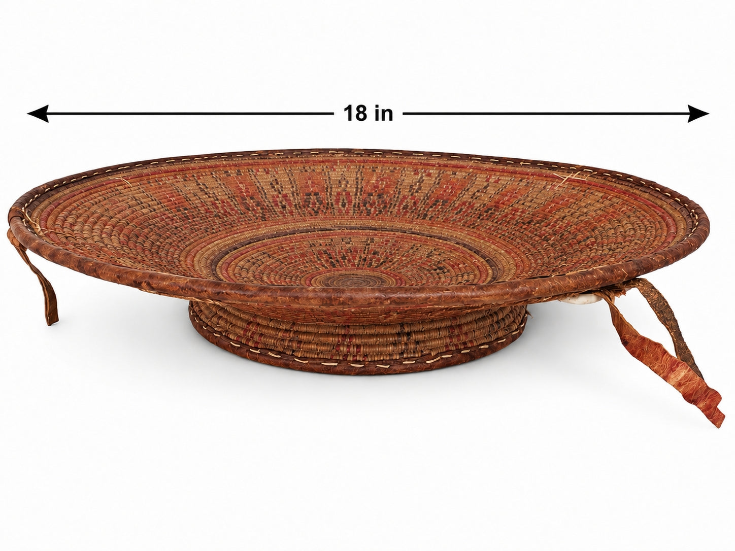A round woven basket tray with a raised base and two hanging ties, shown on a white background with a black dimension arrow labeled 18 in across the top.