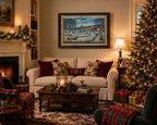 A framed winter landscape painting hangs on a wall above a cream sofa in a warmly lit living room with a fireplace, Christmas tree, plaid armchair, and gift boxes.