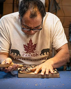 Tom Whonnock Carving one of his First Naration wood carvings