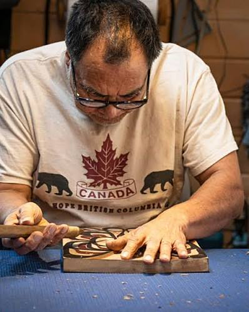 Tom Whonnock Carving one of his First Naration wood carvings