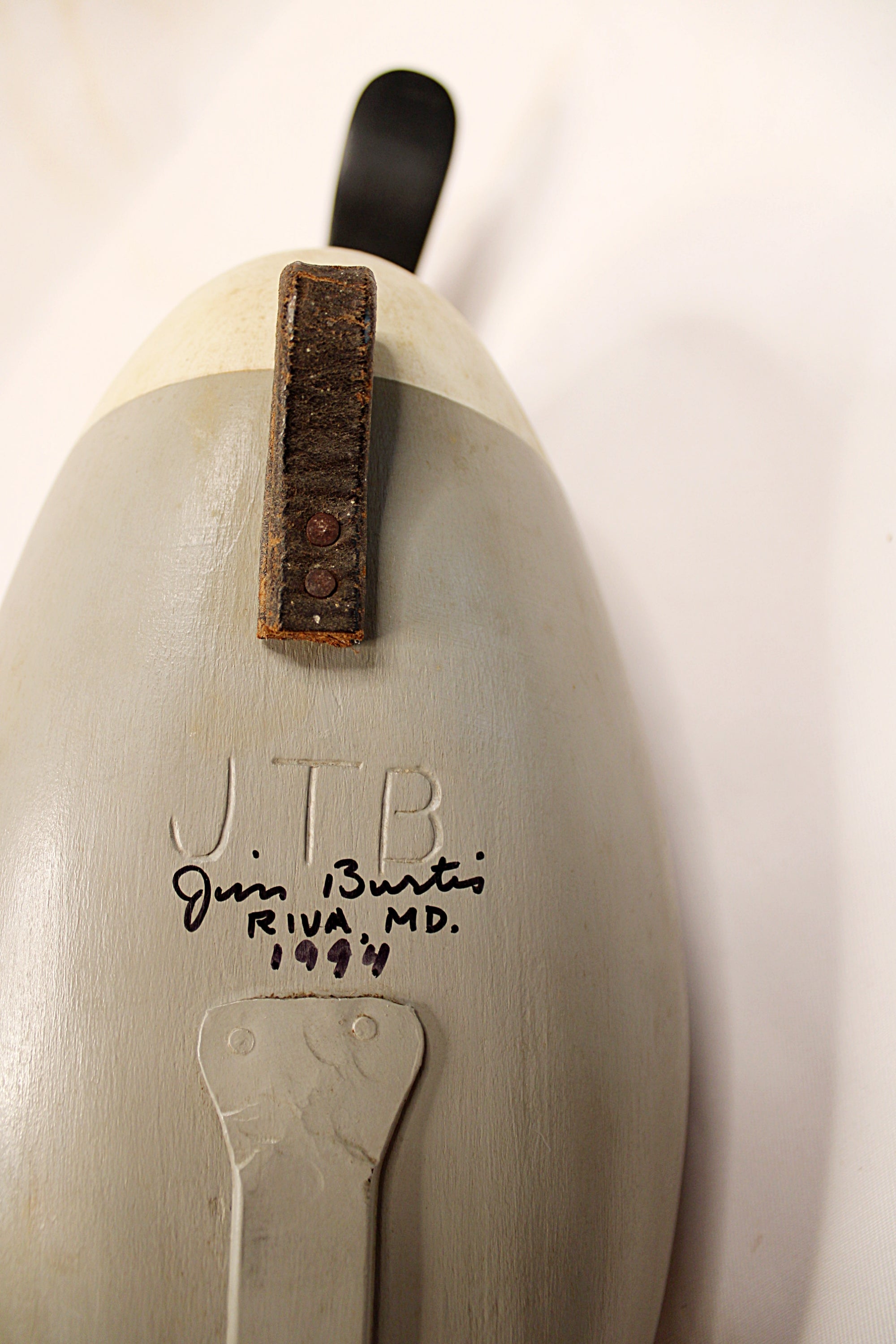 Close-up of a ceramic sculpture with 'JTB' and 'Jim Burtis, Riva MD 1994' marked on it
